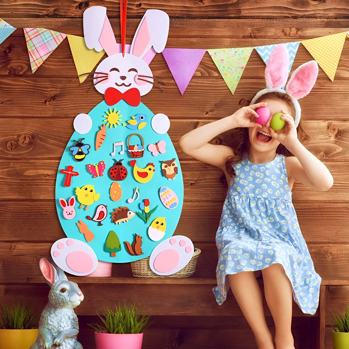Child wearing bunny ears playing with an Easter-themed wall hanging on a wooden background.
