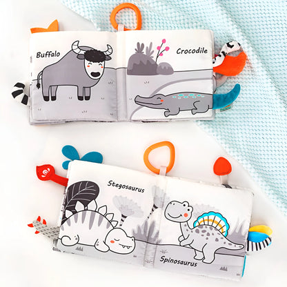 Children's soft book with animal illustrations on a light blue blanket