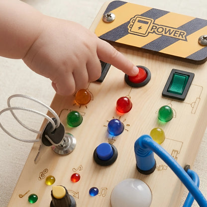 Child's hand interacting with a wooden toy control panel featuring colorful buttons and a power switch.