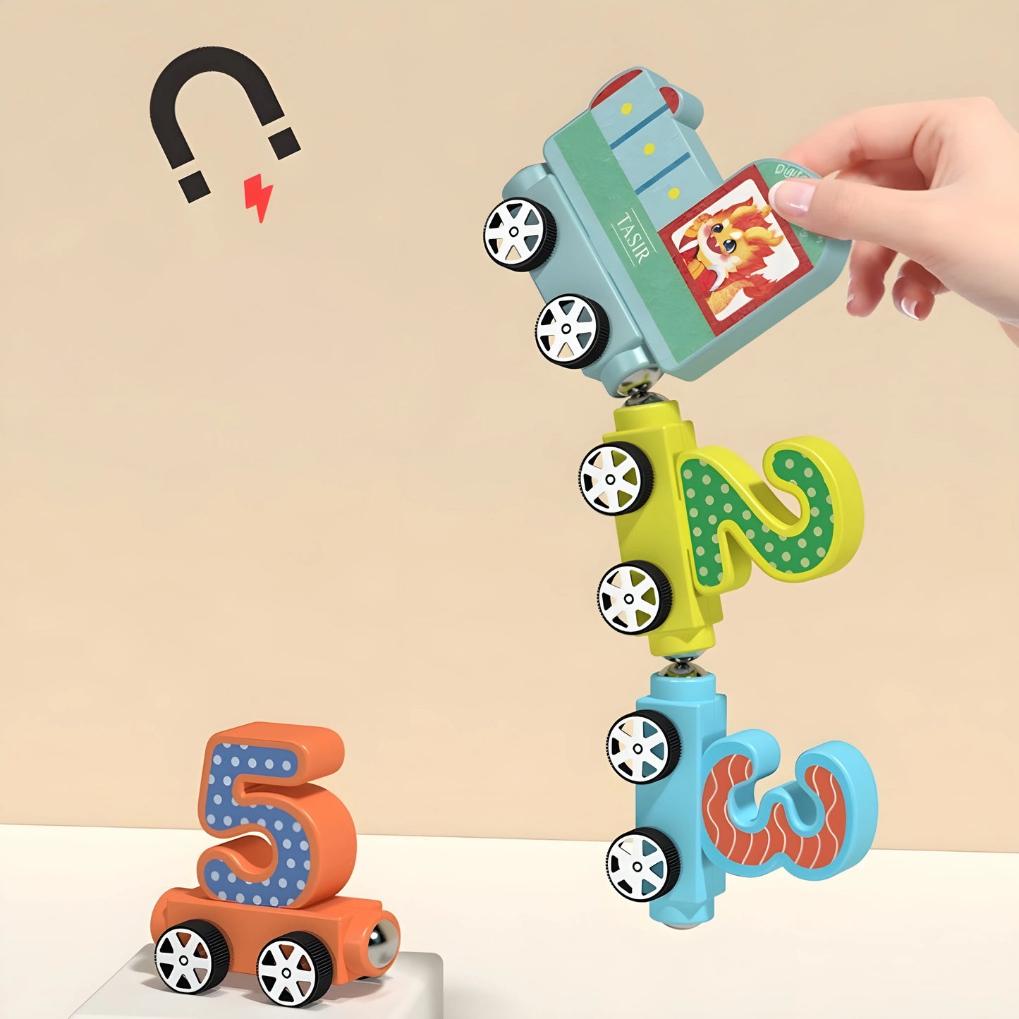 magnetic Toy with number and letter shapes on wheels, held by a hand against a beige background