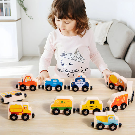 Child playing with magnetic wooden toy cars on a table